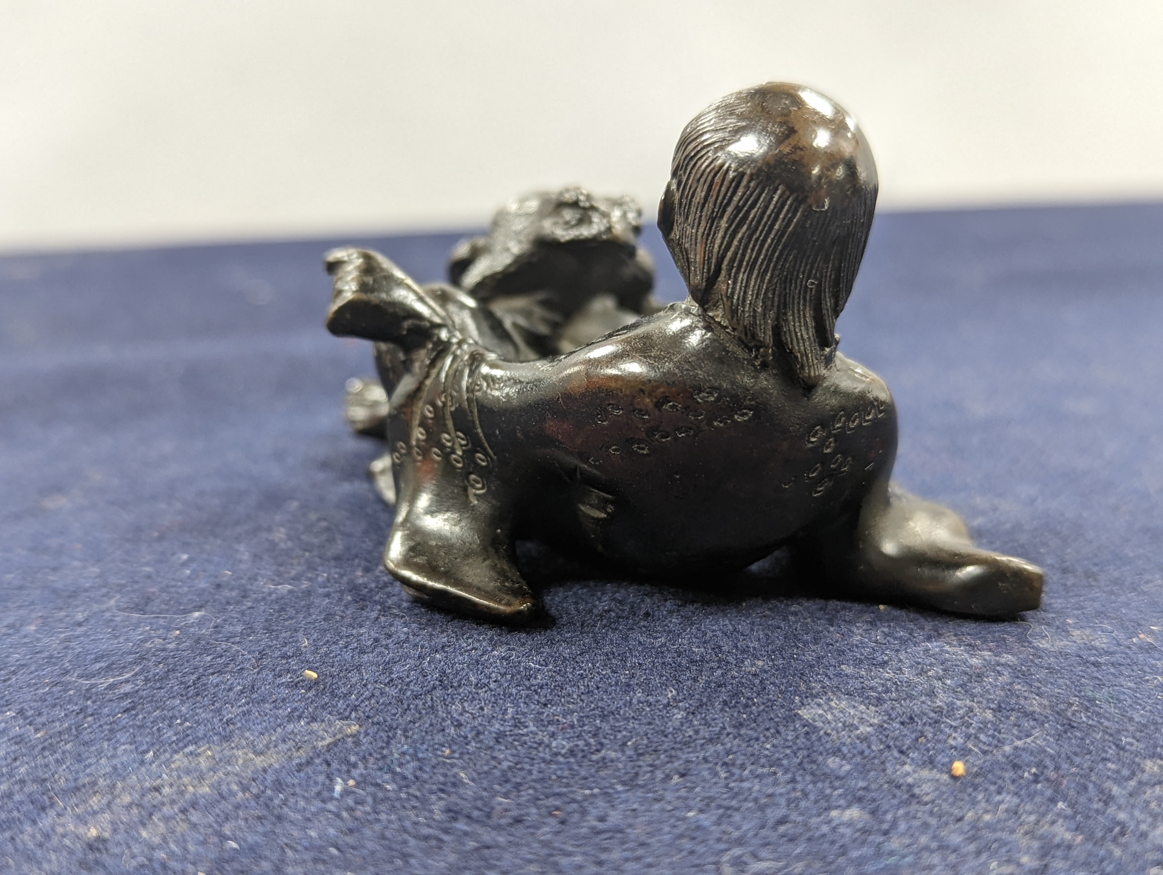 A Chinese bronze group of Liu Hai and a toad, wood stand and a bronze figure of a dog, 9cm